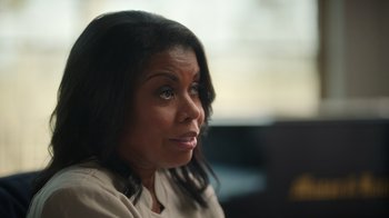 Movie still from “Sidney” (2022), directed by Reginald Hudlin – A person sitting in front of a computer; Close Up shot, Over the shoulder angle