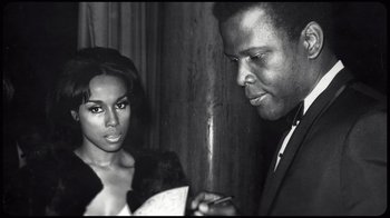 Movie still from “Sidney” (2022), directed by Reginald Hudlin – A black and white photo of a man and a woman; Close Up shot, Low angle