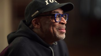 Movie still from “Sidney” (2022), directed by Reginald Hudlin – A person wearing glasses and a hat; Close Up shot, Low angle