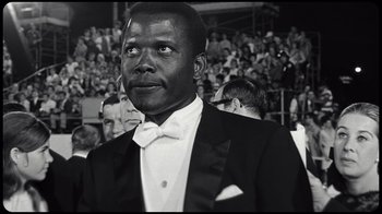 Movie still from “Sidney” (2022), directed by Reginald Hudlin – A black and white photo of a man in a tuxedo; Close Up shot, Low angle