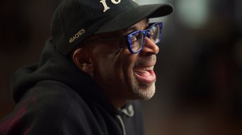 Movie still from “Sidney” (2022), directed by Reginald Hudlin – A person wearing glasses and a hat; Close Up shot, Low angle