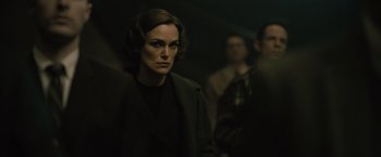 A woman in a black jacket and a man in a black suit