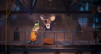 Movie still from “Sing 2” (2021), directed by Christophe Lourdelet – Two cartoon characters on a stage with a brick wall behind them; Wide shot, Low angle