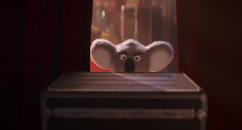 Movie still from “Sing 2” (2021), directed by Christophe Lourdelet – An animal with big eyes is looking through a window; Close Up shot, Low angle