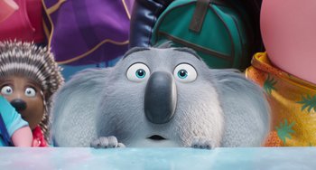 Movie still from “Sing 2” (2021), directed by Christophe Lourdelet – The head and face of an animal with big blue eyes; Close Up shot, Low angle