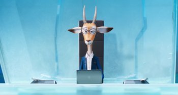 Movie still from “Sing 2” (2021), directed by Christophe Lourdelet – An animated goat sitting in front of a laptop computer; Medium shot, High angle