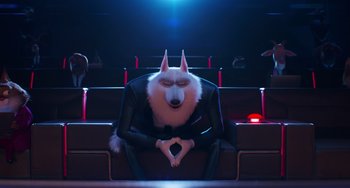 Movie still from “Sing 2” (2021), directed by Christophe Lourdelet – A man with a dog's head sitting in a movie theater; Wide shot, High angle