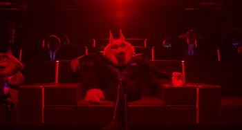 Movie still from “Sing 2” (2021), directed by Christophe Lourdelet – A dog sitting on a couch in a movie theater; Wide shot, Low angle