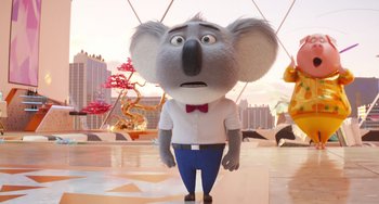 Movie still from “Sing 2” (2021), directed by Christophe Lourdelet – A cartoon of a koala wearing a white shirt and a red bow tie; Medium shot, Low angle