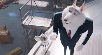 Movie still from “Sing 2” (2021), directed by Christophe Lourdelet – A man and a mouse in a suit and tie; Medium shot, Low angle