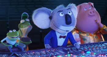 Movie still from “Sing 2” (2021), directed by Christophe Lourdelet – A toy koala wearing a blue jacket and a red bow tie; Medium shot, Low angle