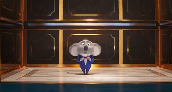 Movie still from “Sing 2” (2021), directed by Christophe Lourdelet – A cartoon character in a blue suit and bow tie standing in front of a wall; Wide shot, Low angle