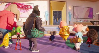 Movie still from “Sing 2” (2021), directed by Christophe Lourdelet – A group of people standing in a living room; Wide shot, Over the shoulder angle