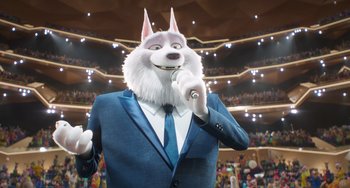 Movie still from “Sing 2” (2021), directed by Christophe Lourdelet – A man in a blue suit and a white wolf mask; Medium shot, Low angle