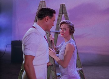 Movie still from “Singin' in the Rain” (1952), directed by Gene Kelly – A man and a woman standing next to each other; Medium shot, Low angle