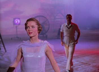 Movie still from “Singin' in the Rain” (1952), directed by Gene Kelly – A man and a woman are dressed in white; Medium shot, Low angle