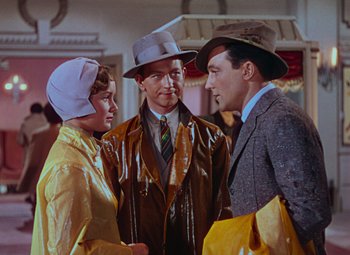 Movie still from “Singin' in the Rain” (1952), directed by Gene Kelly – A group of people standing next to each other in a room; Medium shot, Over the shoulder angle