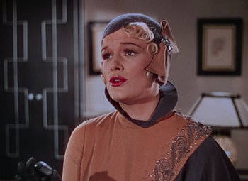 Movie still from “Singin' in the Rain” (1952), directed by Gene Kelly – A woman wearing a head piece in a scene from the television show star trek; Close Up shot, Low angle