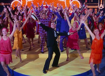 Movie still from “Singin' in the Rain” (1952), directed by Gene Kelly – A group of people are dancing on a dance floor; Wide shot, High angle