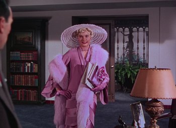 Movie still from “Singin' in the Rain” (1952), directed by Gene Kelly – A woman in a pink dress and a white hat; Medium shot, Low angle