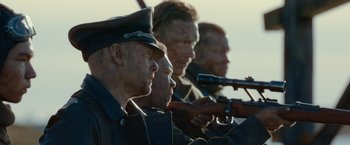 Movie still from “Sisu” (2022), directed by Jalmari Helander – A group of men in military uniforms holding guns; Close Up shot, Low angle