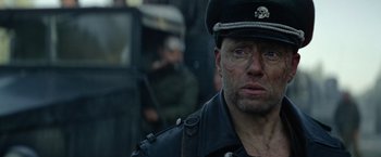 Movie still from “Sisu” (2022), directed by Jalmari Helander – A person wearing a uniform; Close Up shot, Over the shoulder angle