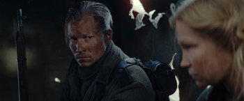 Movie still from “Sisu” (2022), directed by Jalmari Helander – A person with a camera; Close Up shot, Low angle