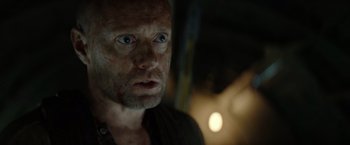 Movie still from “Sisu” (2022), directed by Jalmari Helander – A person looking at the camera; Close Up shot, Over the shoulder angle