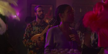 Movie still from “Sitting in Bars with Cake” (2023), directed by Trish Sie – A man and a woman are playing music together; Medium shot, Over the shoulder angle