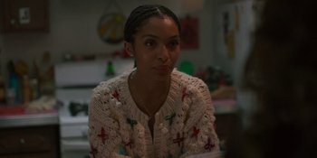 Movie still from “Sitting in Bars with Cake” (2023), directed by Trish Sie – A woman sitting in front of a mirror; Close Up shot, Over the shoulder angle