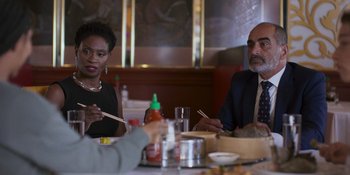 Movie still from “Sitting in Bars with Cake” (2023), directed by Trish Sie – A couple of people sitting at a table with chopsticks; Medium shot, Over the shoulder angle