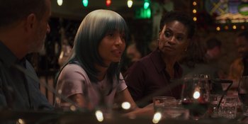 Movie still from “Sitting in Bars with Cake” (2023), directed by Trish Sie – Two women sitting at a table in front of candles; Close Up shot, Over the shoulder angle