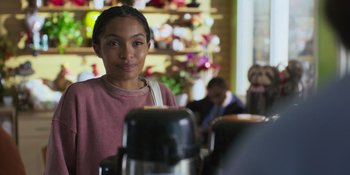Movie still from “Sitting in Bars with Cake” (2023), directed by Trish Sie – A woman standing in front of an espresso machine; Close Up shot, Over the shoulder angle