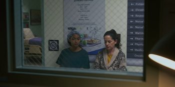 Movie still from “Sitting in Bars with Cake” (2023), directed by Trish Sie – Two women sitting in front of a restaurant window; Medium shot, Over the shoulder angle