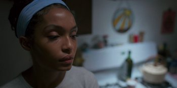 Movie still from “Sitting in Bars with Cake” (2023), directed by Trish Sie – A person wearing a head band; Close Up shot, Over the shoulder angle
