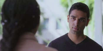 Movie still from “Sitting in Bars with Cake” (2023), directed by Trish Sie – A young man looking at a woman in a black shirt; Close Up shot, Over the shoulder angle