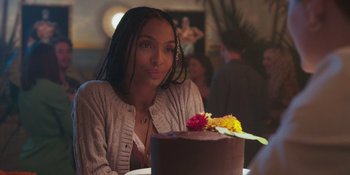 Movie still from “Sitting in Bars with Cake” (2023), directed by Trish Sie – A woman sitting in front of a chocolate cake; Close Up shot, Over the shoulder angle