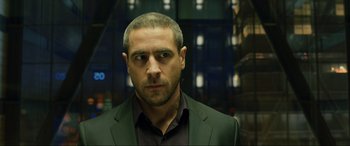 Movie still from “Skyfall” (2012), directed by Sam Mendes – A person wearing a suit and tie; Close Up shot, Over the shoulder angle