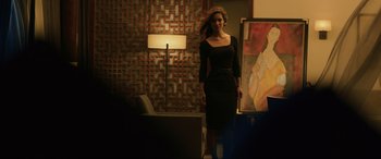Movie still from “Skyfall” (2012), directed by Sam Mendes – A woman in a black dress standing in front of a painting; Wide shot, Over the shoulder angle