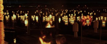 Movie still from “Skyfall” (2012), directed by Sam Mendes – A group of people standing around a fire pit; Extreme Wide shot, High angle