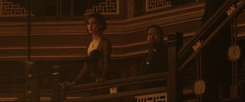 Movie still from “Skyfall” (2012), directed by Sam Mendes – A man and a woman standing on a balcony; Medium shot, Low angle