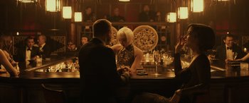 Movie still from “Skyfall” (2012), directed by Sam Mendes – A man and a woman sitting at a bar together; Medium shot, Over the shoulder angle