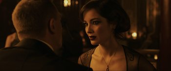 Movie still from “Skyfall” (2012), directed by Sam Mendes – A beautiful woman with dark hair wearing a necklace; Close Up shot, Over the shoulder angle
