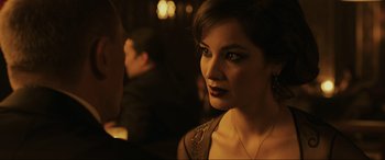 Movie still from “Skyfall” (2012), directed by Sam Mendes – A person wearing a dress; Close Up shot, Over the shoulder angle