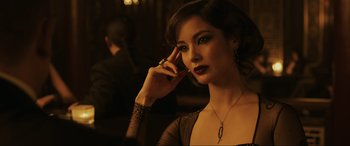 Movie still from “Skyfall” (2012), directed by Sam Mendes – A woman with dark hair wearing a black dress; Close Up shot, Over the shoulder angle