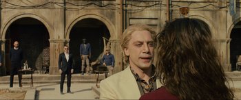 Movie still from “Skyfall” (2012), directed by Sam Mendes – A group of people standing in front of a building; Medium shot, Over the shoulder angle