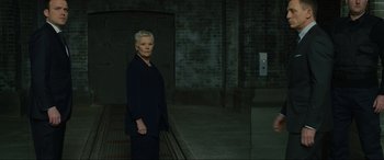 Movie still from “Skyfall” (2012), directed by Sam Mendes – An older woman standing in front of a mirror; Wide shot, Low angle