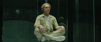 Movie still from “Skyfall” (2012), directed by Sam Mendes – A man sitting on a chair in a room; Medium shot, Low angle