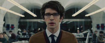 Movie still from “Skyfall” (2012), directed by Sam Mendes – A man wearing glasses and wearing a sweater; Close Up shot, Over the shoulder angle