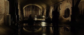 Movie still from “Skyfall” (2012), directed by Sam Mendes – A group of people standing inside of an underground tunnel; Extreme Wide shot, High angle